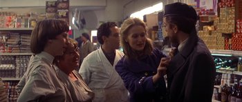 Movie still from “The Deer Hunter” (1978), directed by Michael Cimino – A group of people standing around each other in a room; Medium shot, Over the shoulder angle