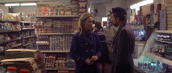 Movie still from “The Deer Hunter” (1978), directed by Michael Cimino – A woman and a man are talking in a store; Medium shot, Over the shoulder angle