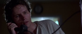 Movie still from “The Deer Hunter” (1978), directed by Michael Cimino – A person holding a microphone; Close Up shot, Low angle