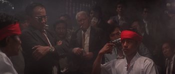 Movie still from “The Deer Hunter” (1978), directed by Michael Cimino – A group of people in a room holding guns; Medium shot, Low angle