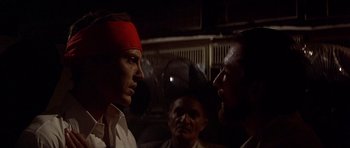 Movie still from “The Deer Hunter” (1978), directed by Michael Cimino – Two men are facing each other in front of a crowd; Close Up shot, Over the shoulder angle