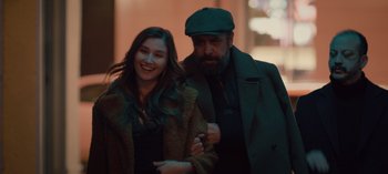 Movie still from “10 Days of a Bad Man” (2023), directed by Uluç Bayraktar – A man and a woman standing next to each other; Medium shot, Over the shoulder angle