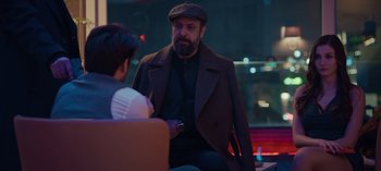 Movie still from “10 Days of a Bad Man” (2023), directed by Uluç Bayraktar – A man in a hat is talking to a woman; Medium shot, Over the shoulder angle