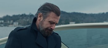 Movie still from “10 Days of a Bad Man” (2023), directed by Uluç Bayraktar – A man with a goatee and a beard on a boat; Close Up shot, Low angle