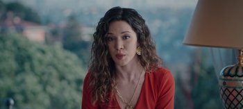 Movie still from “10 Days of a Bad Man” (2023), directed by Uluç Bayraktar – A woman in a red shirt is posing for a picture; Close Up shot, High angle