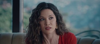 Movie still from “10 Days of a Bad Man” (2023), directed by Uluç Bayraktar – A person wearing a red shirt; Close Up shot, Over the shoulder angle