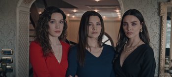 Movie still from “10 Days of a Bad Man” (2023), directed by Uluç Bayraktar – A group of three women standing next to each other; Medium shot, Low angle
