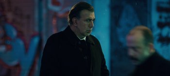 Movie still from “10 Days of a Bad Man” (2023), directed by Uluç Bayraktar – A person wearing a coat; Close Up shot, Low angle