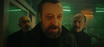 Movie still from “10 Days of a Bad Man” (2023), directed by Uluç Bayraktar – A person with a beard; Close Up shot, Low angle