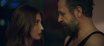 Movie still from “10 Days of a Bad Man” (2023), directed by Uluç Bayraktar – A man and a woman face to face in front of each other; Close Up shot, Over the shoulder angle