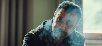 Movie still from “10 Days of a Good Man” (2023), directed by Uluç Bayraktar – A person smoking a cigarette; Close Up shot, Over the shoulder angle
