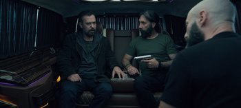 Movie still from “10 Days of a Good Man” (2023), directed by Uluç Bayraktar – Two men sitting in the back of a car; Medium shot, Over the shoulder angle