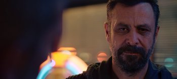 Movie still from “10 Days of a Good Man” (2023), directed by Uluç Bayraktar – A person with a beard; Close Up shot, Over the shoulder angle