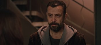 Movie still from “10 Days of a Good Man” (2023), directed by Uluç Bayraktar – A person with a beard; Close Up shot, Over the shoulder angle