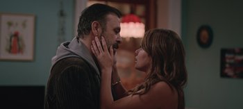 Movie still from “10 Days of a Good Man” (2023), directed by Uluç Bayraktar – A man and a woman touching their faces together; Close Up shot, Over the shoulder angle