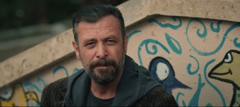 Movie still from “10 Days of a Good Man” (2023), directed by Uluç Bayraktar – A person with a beard; Close Up shot, Low angle