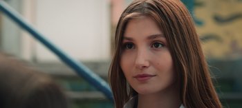 Movie still from “10 Days of a Good Man” (2023), directed by Uluç Bayraktar – A young woman's face with long brown hair; Close Up shot, Over the shoulder angle
