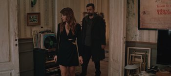 Movie still from “10 Days of a Good Man” (2023), directed by Uluç Bayraktar – A man and a woman are walking in a room; Medium shot, High angle