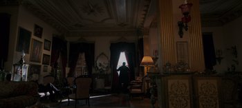 Movie still from “10 Days of a Good Man” (2023), directed by Uluç Bayraktar – A man standing in front of a window in a living room; Extreme Wide shot, Low angle