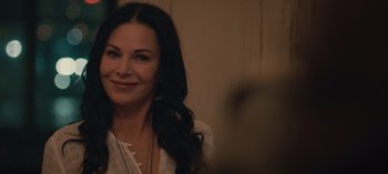 Movie still from “10 Days of a Good Man” (2023), directed by Uluç Bayraktar – A woman with long black curly hair smiling; Close Up shot, Over the shoulder angle