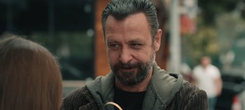 Movie still from “10 Days of a Good Man” (2023), directed by Uluç Bayraktar – A person with a beard; Close Up shot, Over the shoulder angle