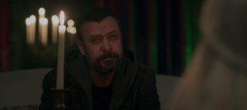 Movie still from “10 Days of a Good Man” (2023), directed by Uluç Bayraktar – A person sitting in a room; Close Up shot, Over the shoulder angle