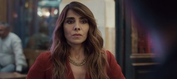Movie still from “10 Days of a Good Man” (2023), directed by Uluç Bayraktar – A person with long hair wearing a necklace; Close Up shot, Over the shoulder angle