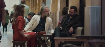 Movie still from “10 Days of a Good Man” (2023), directed by Uluç Bayraktar – Two men sitting on a bench talking to each other; Medium shot, Over the shoulder angle