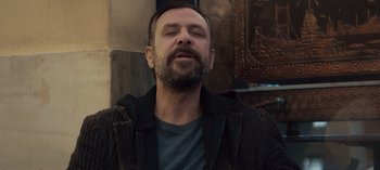 Movie still from “10 Days of a Good Man” (2023), directed by Uluç Bayraktar – A man with a beard is looking up at the sky; Close Up shot, Low angle