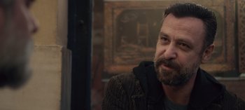 Movie still from “10 Days of a Good Man” (2023), directed by Uluç Bayraktar – A person with a beard; Close Up shot, Over the shoulder angle