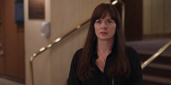 Movie still from “13: The Musical” (2022), directed by Tamra Davis – A woman in a black shirt standing in front of a staircase; Close Up shot, Over the shoulder angle