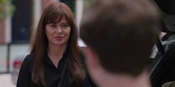 Movie still from “13: The Musical” (2022), directed by Tamra Davis – A woman in a black shirt is standing next to a man; Close Up shot, Over the shoulder angle