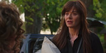 Movie still from “13: The Musical” (2022), directed by Tamra Davis – A person holding a paper bag; Close Up shot, Over the shoulder angle