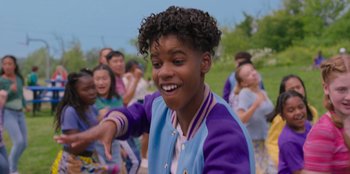 Movie still from “13: The Musical” (2022), directed by Tamra Davis – A group of young people dancing in a field; Close Up shot, Over the shoulder angle