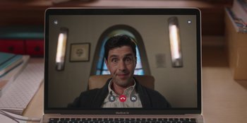 Movie still from “13: The Musical” (2022), directed by Tamra Davis – A man sitting in front of a computer screen; Close Up shot, Over the shoulder angle