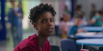 Movie still from “13: The Musical” (2022), directed by Tamra Davis – A young girl with a red shirt is looking up; Close Up shot, Over the shoulder angle