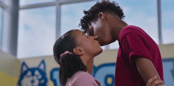 Movie still from “13: The Musical” (2022), directed by Tamra Davis – A couple of people that are kissing in a room; Close Up shot, Low angle