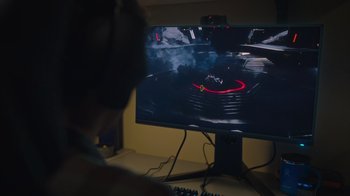 Movie still from “1UP” (2022), directed by Kyle Newman – A person playing a video game on a computer screen; Extreme Close Up shot, High angle