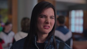Movie still from “1UP” (2022), directed by Kyle Newman – A person wearing a jacket; Close Up shot, Over the shoulder angle