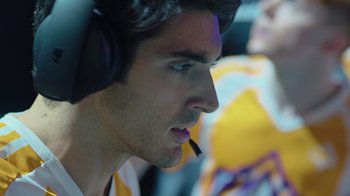 Movie still from “1UP” (2022), directed by Kyle Newman – A person with a headset on; Close Up shot, Low angle
