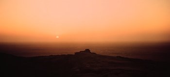 Movie still from “2001: A Space Odyssey” (1968), directed by Stanley Kubrick – The sun is setting over the ocean on a hazy day; Extreme Wide shot, Low angle