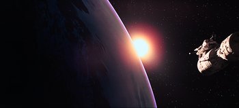 Movie still from “2001: A Space Odyssey” (1968), directed by Stanley Kubrick – An image of an image of the sun and the earth from outer space; Extreme Wide shot, High angle