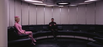 Movie still from “2001: A Space Odyssey” (1968), directed by Stanley Kubrick – A man sitting on a couch in front of a woman; Wide shot, Over the shoulder angle