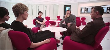 Movie still from “2001: A Space Odyssey” (1968), directed by Stanley Kubrick – A group of people sitting around a table; Wide shot, High angle