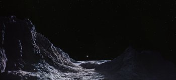 Movie still from “2001: A Space Odyssey” (1968), directed by Stanley Kubrick – An image of an image of the moon taken from the surface of the earth; Extreme Wide shot, High angle