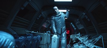 Movie still from “2001: A Space Odyssey” (1968), directed by Stanley Kubrick – A man in a space suit standing in a room; Medium shot, Overhead angle