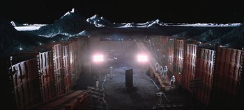Movie still from “2001: A Space Odyssey” (1968), directed by Stanley Kubrick – A group of people standing in a room with lights on them; Extreme Wide shot, High angle
