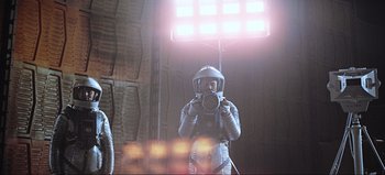 Movie still from “2001: A Space Odyssey” (1968), directed by Stanley Kubrick – A person in a spacesuit taking a picture; Wide shot, Low angle
