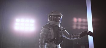 Movie still from “2001: A Space Odyssey” (1968), directed by Stanley Kubrick – A man in a spacesuit holding a video camera; Medium shot, Low angle