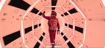 Movie still from “2001: A Space Odyssey” (1968), directed by Stanley Kubrick – A man in a space suit walking through a tunnel; Wide shot, Low angle